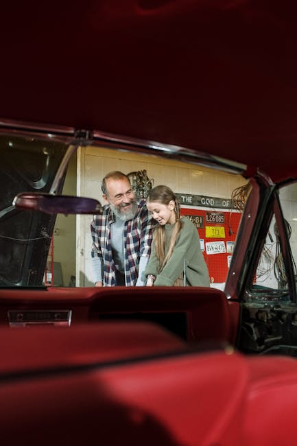 A heartwarming scene of a father and daughter bonding in a vintage car workshop.